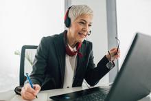 female with phone headset on computer