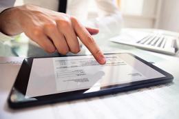 Employers, your premium rate notice is going paperless, person on tablet